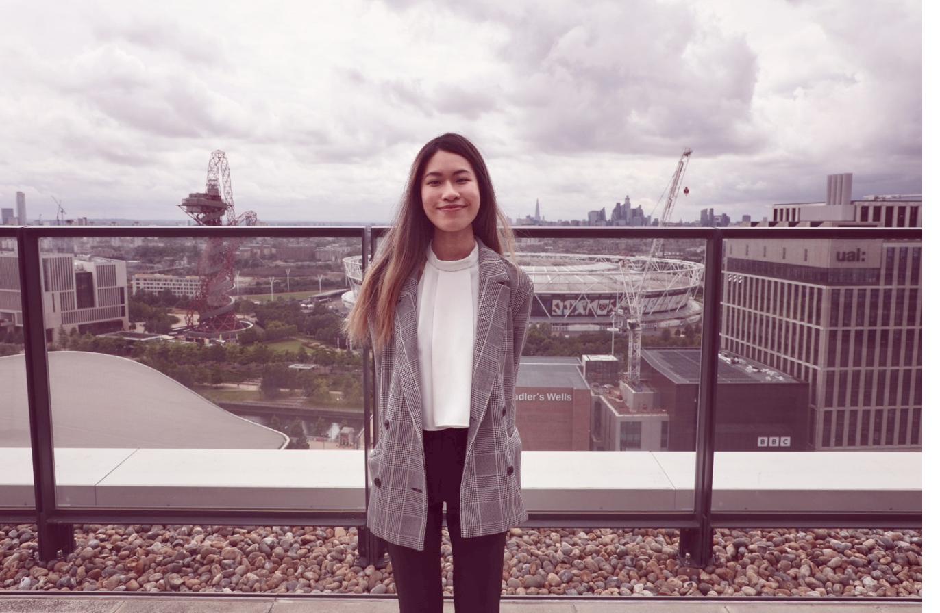 Jolene Gan on the FCA building rooftop, London skyline behind